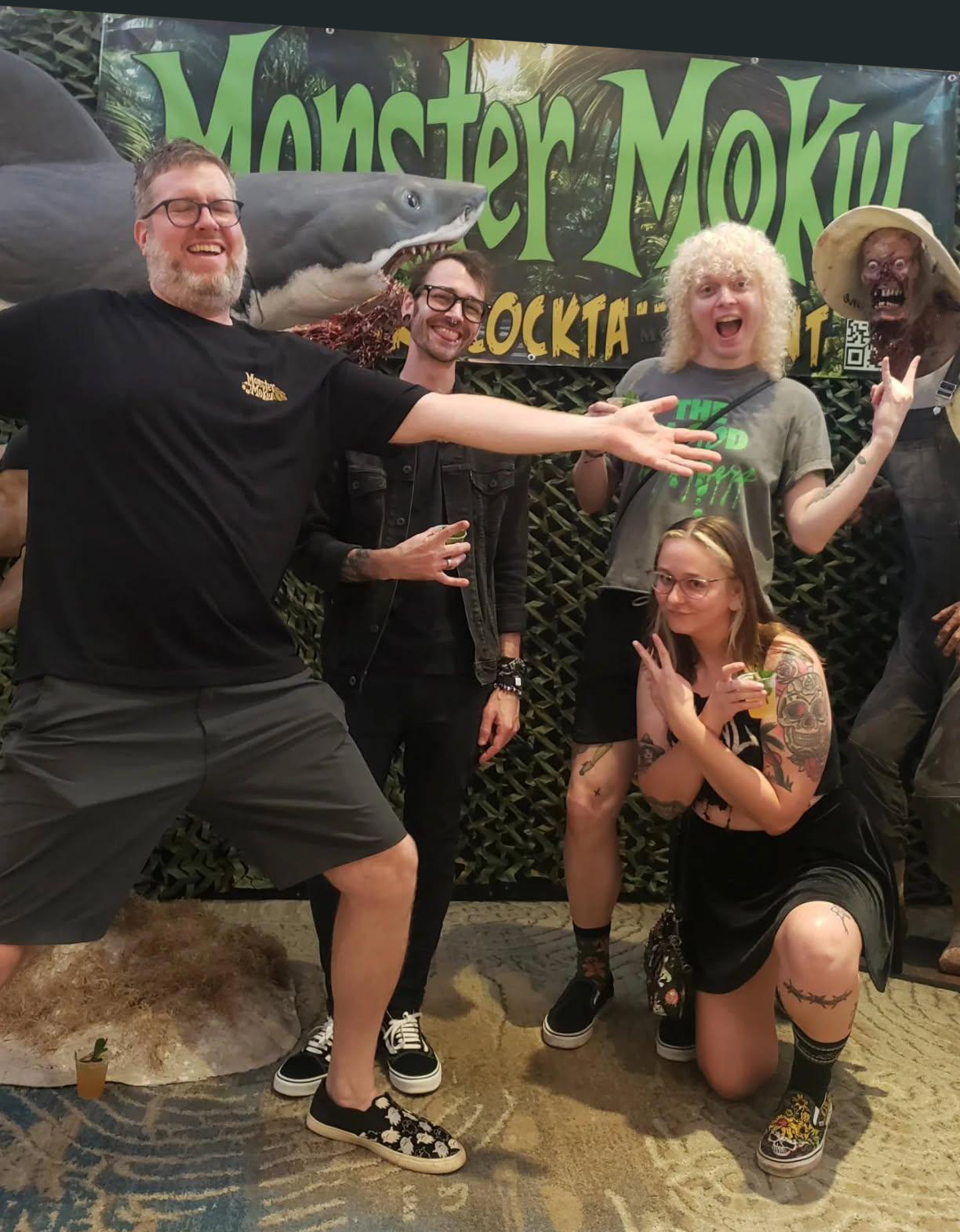 Friends posing with monsters at the Monster Moku photo backdrop